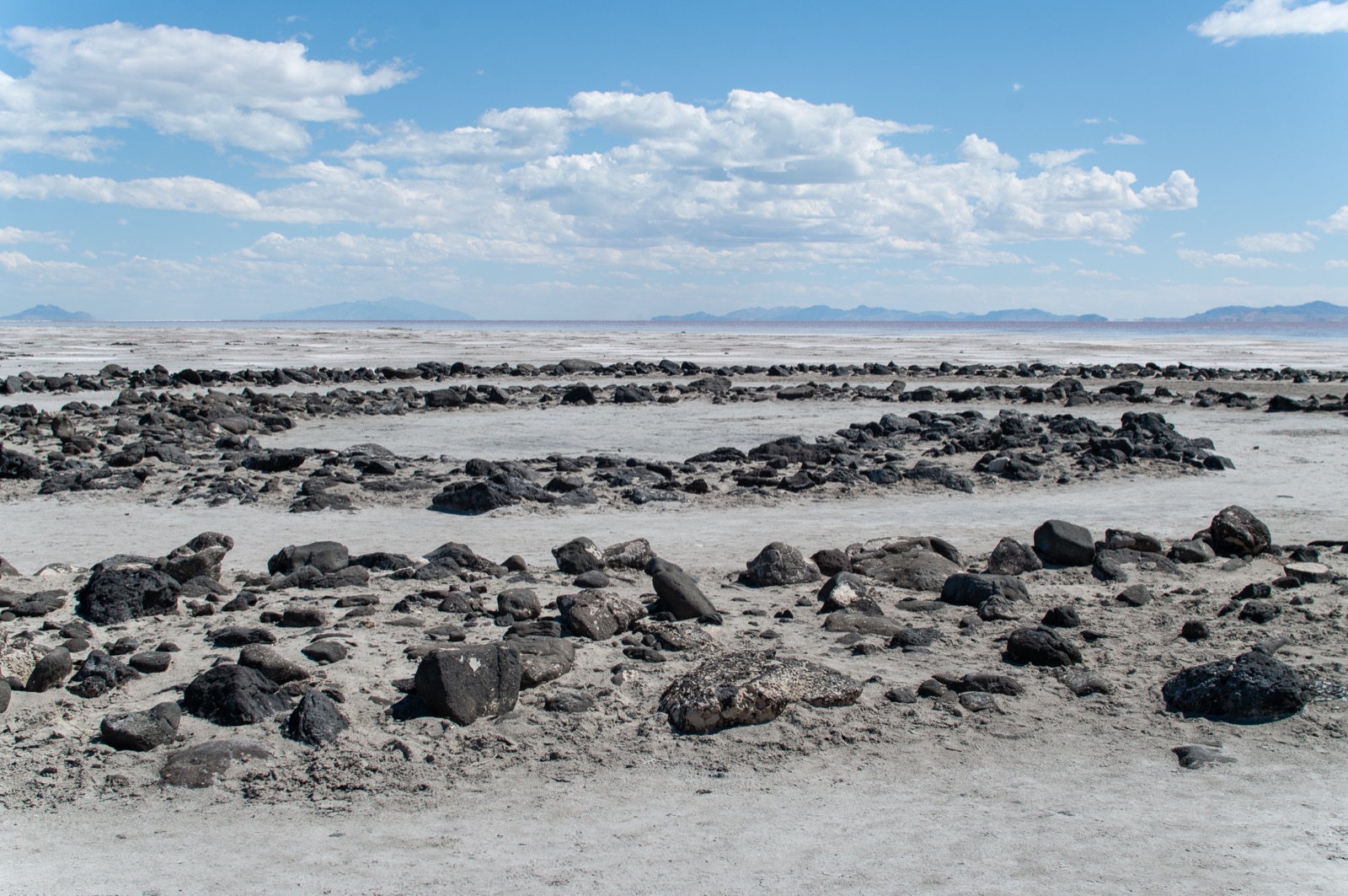 Robert Smithson's Spiral Jetty on the dry, cracked lakebed of the Great Salt Lake in 2018, once underwater and now stranded on exposed playa
